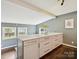 Kitchen island featuring light gray cabinets, gold hardware, and quartz countertops with a stylish lighting fixture at 827 Fairbanks Rd, Charlotte, NC 28210