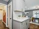 A beautifully remodeled kitchen with white cabinets, stainless steel appliances, and a view into the living space at 827 Fairbanks Rd, Charlotte, NC 28210