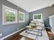 Cozy living room features a comfortable sofa, bright windows, and a stylish rug on dark hardwood floors at 827 Fairbanks Rd, Charlotte, NC 28210