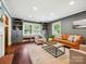 Cozy living room featuring built-in shelving, a window seat, and hardwood floors at 827 Fairbanks Rd, Charlotte, NC 28210