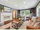 Stylish living room showcasing a fireplace, built-in shelving, and ample natural light at 827 Fairbanks Rd, Charlotte, NC 28210