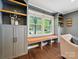Bright living room with a window seat, built-in cabinets and hardwood flooring at 827 Fairbanks Rd, Charlotte, NC 28210