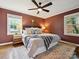 Cozy bedroom features a king bed, natural light, and a ceiling fan at 827 Fairbanks Rd, Charlotte, NC 28210