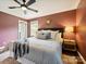 Bedroom features a king bed, natural light, ceiling fan, and en-suite bathroom at 827 Fairbanks Rd, Charlotte, NC 28210