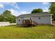 Backyard featuring a house exterior with a deck and a well-maintained lawn at 835 Jet St, Kannapolis, NC 28081