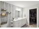 Spacious bathroom featuring a double vanity and patterned accent wall at 835 Jet St, Kannapolis, NC 28081