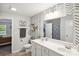 Modern bathroom with double vanity, patterned accent wall, and separate toilet area at 835 Jet St, Kannapolis, NC 28081