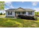 Charming single-story home featuring a welcoming front porch and well-maintained landscaping at 835 Jet St, Kannapolis, NC 28081