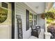 Up-close, the covered front porch includes seating, a welcome sign, and a hanging flower basket at 835 Jet St, Kannapolis, NC 28081