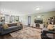 Open living room featuring wood floors, a large area rug, tv, and modern decor at 835 Jet St, Kannapolis, NC 28081