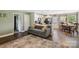 Open living room featuring wood floors, a large area rug, modern decor, and open access to kitchen at 835 Jet St, Kannapolis, NC 28081