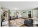 Open living room featuring wood floors, a large area rug, tv, and modern decor at 835 Jet St, Kannapolis, NC 28081
