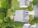 Aerial view of the home showcasing its landscaped yard, firepit, patio, mature trees, and proximity to neighbors at 8605 Soaring Eagle Ln, Waxhaw, NC 28173