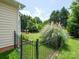Well-maintained backyard features a black fence, mature trees, and an established fire pit area at 8605 Soaring Eagle Ln, Waxhaw, NC 28173