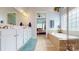 Bright bathroom featuring double vanity, a soaking tub, and access to the main bedroom at 8605 Soaring Eagle Ln, Waxhaw, NC 28173