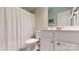Cozy bathroom with a white vanity, toilet, shower curtain, and calming color palette at 8605 Soaring Eagle Ln, Waxhaw, NC 28173