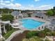 A swimming pool with a waterslide, lounging area, and well-kept landscaping at 8605 Soaring Eagle Ln, Waxhaw, NC 28173