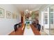 Dining area with hardwood floors and shiplap accents, open to other living spaces at 8605 Soaring Eagle Ln, Waxhaw, NC 28173