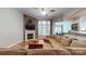 Comfortable living room with stone fireplace, large windows, and cozy sectional at 8605 Soaring Eagle Ln, Waxhaw, NC 28173