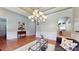 Elegant living room with hardwood floors, a decorative chandelier, and an open layout at 8605 Soaring Eagle Ln, Waxhaw, NC 28173