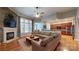 Open-concept living room with a fireplace, large sectional sofa, and view into kitchen at 8605 Soaring Eagle Ln, Waxhaw, NC 28173