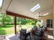 Inviting covered patio with outdoor seating, a ceiling fan, a skylight, and a view of the landscaped backyard at 8605 Soaring Eagle Ln, Waxhaw, NC 28173