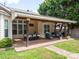Outdoor patio featuring a ceiling fan, dining and lounging furniture, and access to a landscaped backyard at 8605 Soaring Eagle Ln, Waxhaw, NC 28173