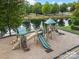 A playground set with slides and climbing elements is available near a small pond at 8605 Soaring Eagle Ln, Waxhaw, NC 28173