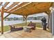 Inviting backyard patio under a pergola, complete with outdoor seating and a barbecue grill at 9505 Cotswood Pl, Gastonia, NC 28056