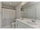 A well-lit bathroom features a double sink vanity and a shower with decorative shower curtain at 9505 Cotswood Pl, Gastonia, NC 28056