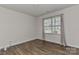 Bedroom with neutral walls, hardwood flooring, and a window with natural light at 9505 Cotswood Pl, Gastonia, NC 28056
