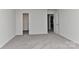 Bright bedroom featuring neutral walls, plush carpeting, and a double door closet for ample storage at 9505 Cotswood Pl, Gastonia, NC 28056