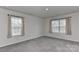 A well-lit bedroom features two bright windows and neutral carpeting, providing a comfortable space at 9505 Cotswood Pl, Gastonia, NC 28056