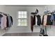 A well-organized walk-in closet includes shelving, hanging rods and a view from a bright window at 9505 Cotswood Pl, Gastonia, NC 28056