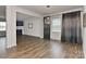 Open dining area with hardwood floors and a modern light fixture, with views to a living room at 9505 Cotswood Pl, Gastonia, NC 28056