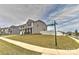 Charming two-story home boasting stone accents, gray siding, a well-manicured lawn, and a white fence at 9505 Cotswood Pl, Gastonia, NC 28056