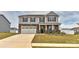 Charming two-story home featuring a two-car garage, stone accents, and a well-manicured front yard at 9505 Cotswood Pl, Gastonia, NC 28056