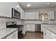 Modern kitchen features white cabinets, granite countertops, and stainless steel appliances at 9505 Cotswood Pl, Gastonia, NC 28056