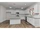 Modern kitchen features white cabinets, granite countertops, and a stylish kitchen island at 9505 Cotswood Pl, Gastonia, NC 28056