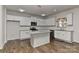 Well-equipped kitchen features white cabinets, granite countertops, stainless steel appliances at 9505 Cotswood Pl, Gastonia, NC 28056