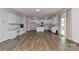 Open-concept kitchen boasts white cabinets, granite countertops, and modern stainless appliances at 9505 Cotswood Pl, Gastonia, NC 28056