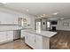 Open kitchen with an island, granite counters, stainless appliances, and modern lighting at 9505 Cotswood Pl, Gastonia, NC 28056