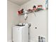 Convenient laundry room with a modern washing machine, storage shelves, and tiled flooring at 9505 Cotswood Pl, Gastonia, NC 28056