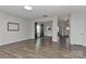Open concept living room with hardwood floors, neutral walls, and seamless access to dining area at 9505 Cotswood Pl, Gastonia, NC 28056