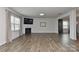 Bright living room with hardwood floors, fireplace, and large windows providing ample natural light at 9505 Cotswood Pl, Gastonia, NC 28056