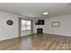 Spacious living room with hardwood floors, a fireplace, and large windows providing natural light at 9505 Cotswood Pl, Gastonia, NC 28056