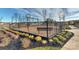 Community playground with swings, slides and play structure, surrounded by a secure fence at 9505 Cotswood Pl, Gastonia, NC 28056