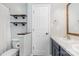 Cozy bathroom featuring a toilet and vanity with a framed mirror and open wood shelving at 9593 Indian Beech Nw Ave, Concord, NC 28027