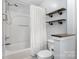 Bright bathroom featuring shower-tub combo, floating shelves, and neutral color palette at 9593 Indian Beech Nw Ave, Concord, NC 28027