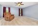Bedroom with comfortable chair, natural light from two windows, and neutral colored carpet at 9593 Indian Beech Nw Ave, Concord, NC 28027